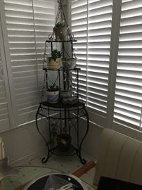 This is a wrought-iron plant  stand. 