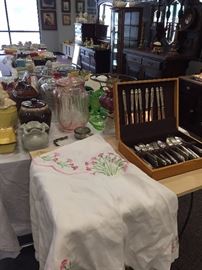 embroidered table cloths, pillow cases, and dresser scarves plus flatware--