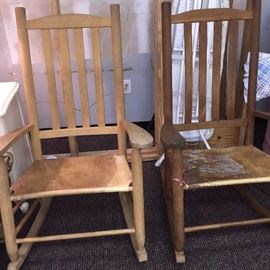 several cow hide chairs and rockers