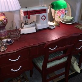 cute red desk plus a portable Singer sewing machine