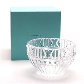 Tiffany & Co. Crystal "Atlas" Bowl: A Tiffany & Co. crystal Atlas bowl. The piece has a deep linear cut throughout and is marked to the underside “Tiffany & Co.” The bowl is accompanied by a Tiffany box.