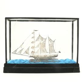 Sterling Silver Filigree Frigate Ship: A vintage sterling silver ship. The piece was made in the form of an antique frigate ship from 93.59% silver. Featured is the filigree decoration on the sails and exterior of the ship. The ship was purchased from a Makassar, Indonesia souvenir shop with the store’s information present on the underside. The approximate weight is 1.53 ozt.