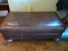 Two oversized matching leather chairs with ottomans