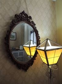 carved walnut mirror with wrought iron entry lamp