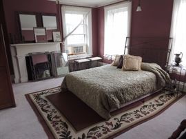 iron bed with matching side tables, mirrors, rug