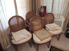 four caned back chairs