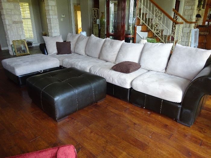 leather/material large sectional with 2 ottomans. one lifts open