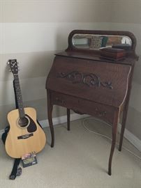 Vintage writing desk and Yamaha guitar