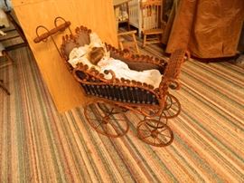 Porcelain doll in vintage doll carriage 