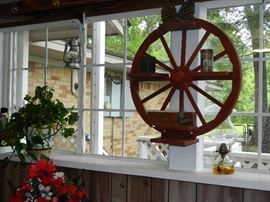 One of two handmade wagon wheel shelves
