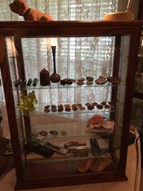 This showcase is full of Ammonite, Amethist Quartz Crystal, Natural Obsidian Quartz Crystal, Vaseline Scottie, Pocket knives, child shoe mold