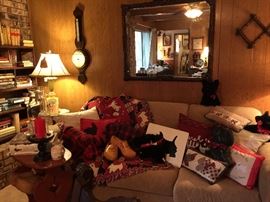 The den is very cozy, a wonderful gently used sleeper sofa, lots of Scottie cushions, throw and soft toys.  A large Mahogany mirror, lamps, oak bookcase, books, cottage style table, vintage pottery, clogs.