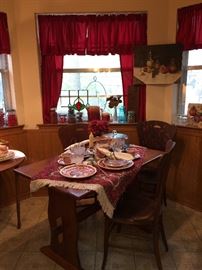 This is the Kitchen nook, wonderful table, three tiger oak chairs, Masons red transfer ware china, vintage glass, old mason jars, small stain glass piece, still life oil