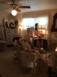 This is the shabby room.  Vintage five drawer chest, French Provincial style side table, vintage wicker table with shaped glass top, painted wash stand, screen, vintage framed photographs, linens, prints, lamps