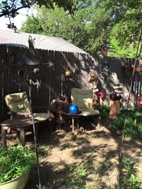 Wood garden furniture, lots of hanging decor, metal tables and seasonal art