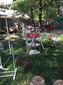 Metal and glass table, vintage push mowers, pepsi display shelf, coca cola crates, planters