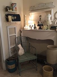 A close look at the mantle, metal shelf with old tins, and vintage trays, ice cream maker