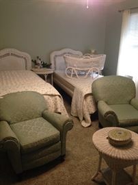  White wicker twin headboards, oval table, round table, and cradle; his & hers upholstered chairs