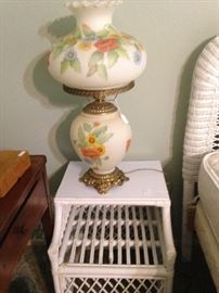 One of two white wicker side tables; one of several "Gone With the Wind" lamps