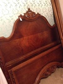 Antique full bed has headboard and footboard.