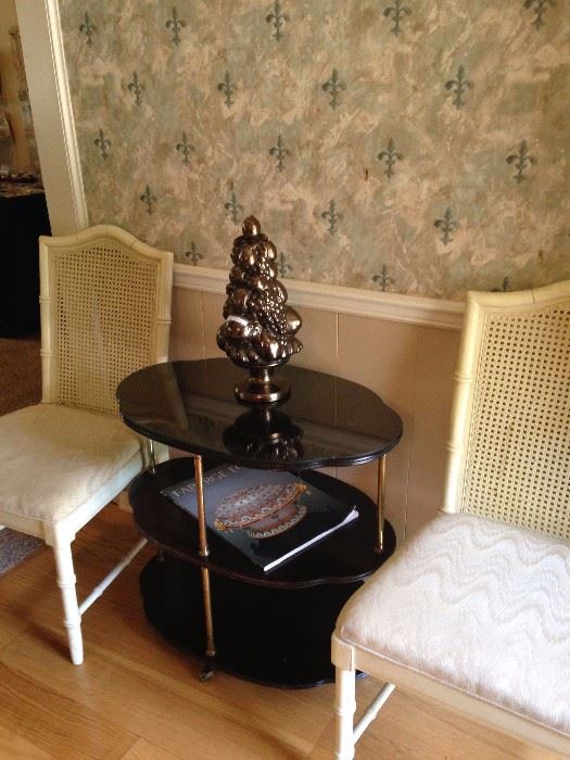Two of the dining room chairs; black oval 3-tier table