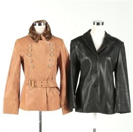 Women's Leather Jackets by Calvin Klein and Anne Klein: A pair of women’s leather jackets. Included is one black jacket and one brown. The brown leather jacket has a double breasted button closure and an adjustable belt at the waist with a faux fur collar liner. The jackets are marked, Anne Klein and Calvin Klein.