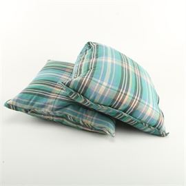 Plaid Print Throw Pillows: A pair of plaid print throw pillows. This pair features two square throw pillows with a plaid-printed fabric of tones of black, blue, green and pink. They are unmarked.