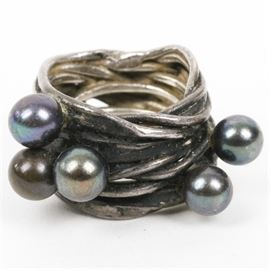 Sterling Silver and Black Pearl Statement Ring: A vintage sterling silver statement ring. This handcrafted ring features multiple interlocking sterling silver rows accented by five dyed black pearls.