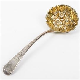 1803 George Smith Sterling Silver Bon Bon Spoon: An 1803 sterling silver bon bon spoon by London silversmith George Smith. This features a gold washed openwork bowl with repoussé flower blossom ornamentation, and an arching tipped handle with bright-cut decoration. It is marked “G.S” in a rectangular cartouche, and the four hallmarks of a lion passant, a crowned leopards head, “H”, and a King George duty mark. The approximate weight is 1.687 ozt.