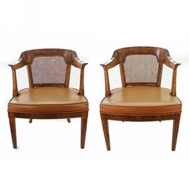 Pair of Vintage Henredon Armchairs: A pair of vintage armchairs by Henredon. Each chair features a cane back, curved crest rail, curved arm rests, padded vinyl upholstered seat, and four tapered legs. The chairs are marked “Henredon Fine Furniture” the bottom. Items match 17LAX169-002.