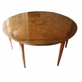 Vintage Henredon Dining Table: A vintage Henredon dining table. This circular shaped table has a hexagon inlay design on the table top, simple apron, and sits on six tapered legs. The table is marked on the bottom “Henredon Fine Furniture”.