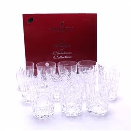 Waterford Crystal Limited Edition "12 Days of Christmas" Double Old-Fashioned Glasses: A group of old-fashioned glasses in the 12 Days of Christmas pattern by Waterford Crystal. There are twelve in total with frosted holiday designs with cross-hatching details. They are marked, “Waterford”. A booklet is included to explain each pattern and image.