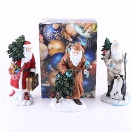 Limited Edition Pipka "Sierra Santa," "Antarctic Santa," "Santa on the Go" Figurines: A collection of limited edition Santa Claus figurines manufactured by Pipka. This collection includes three individually titled and numbered resin statues. Featured figurines include one in a brown coat and backpack, holding a small pine tree, marked to the underside “Sierra Santa, 100/3200, Memories of Christmas #13986, ©2006- Prizm inc.;” one hiking Santa, accompanied by a small family of penguins, marked to the underside “Antarctic Santa, 0174/3200, Memories of Christmas 7141201, ©2013 Pipka, ©2013 PMI, Made in China;” and one Santa in a red coat, holding a suitcase and small pine tree, marked to the underside “Santa on the Go, Limited Edition, Pipka Memories of Christmas, number 1547/4500, Design #13963, ©2003-Prizm inc, Made in China.”
