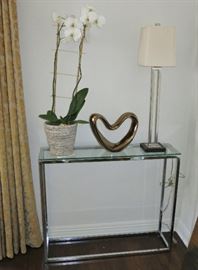 Pair of sleek Chrome and Glass Console Table; Pair of Modern Brushed Steel Table Lamps; Glazed Open Heart