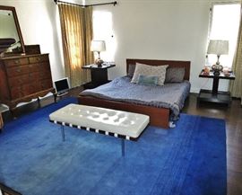 Platform Queen Bed; Blue Rug; Fine George II Inlaid & Burled Walnut Chest; pair of Tiered Side Tables; Pair of Silver Metal Lamps; small Flat Screen TV