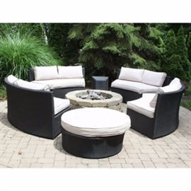 Contemporary Stainless Steel Wicker Style Patio Suite: A modern stainless steel woven, wicker style patio suite. Included are four rounded black wicker couches, a round ottoman and two matching accent tables. Couches and ottoman include removable cushions in a light ecru color.