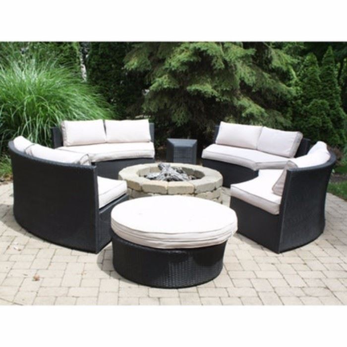 Contemporary Stainless Steel Wicker Style Patio Suite: A modern stainless steel woven, wicker style patio suite. Included are four rounded black wicker couches, a round ottoman and two matching accent tables. Couches and ottoman include removable cushions in a light ecru color.
