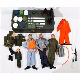 Vintage Mattel G.I.Joe Footlocker Storage Box, Dolls, and Accessories Collection: A vintage Mattel G.I.Joe footlocker storage box, dolls, and accessories collection. Included is a hinged painted wood green footlocker box with a blond G.I. Joe doll in Navy outfit, a brown hair talking G.I. Joe doll in Army outfit, and a talking G.I. Joe doll with a blue jumpsuit and orange air vest with original metal dog tags. Also included is an assortment of scuba gear, an orange jumpsuit, a variety of hats, and more.