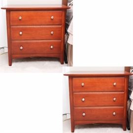 Thomasville "Impressions" Cherry Wood Nightstands: A pair of Thomasville Impressions cherry wood nightstands. Featured are two footed nightstands with three drawers each, silver tone metal pulls, and dovetail construction.