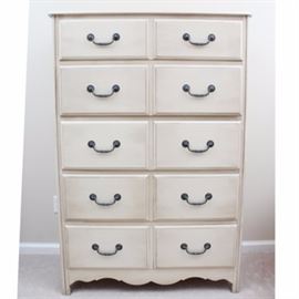 Lightly Distressed Style Chest of Drawers: A lightly distressed style chest of drawers. This chest with five drawers features a shaped apron, embossed metal pulls, and dove tail construction. This piece has a lightly distressed taupe finish.