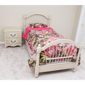 Twin Bed and Matching Nightstand in Lightly Distressed Style: A twin bed and matching nightstand. Featured is a twin bed frame with a fanback headboard, matching footboard, and side rails with a lightly distressed taupe finish. The matching footed nightstand features dovetail construction, two drawers with embossed metal handles and a shaped apron.