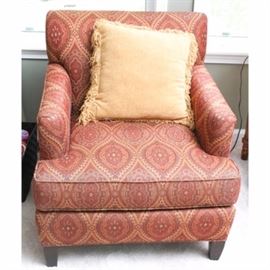 Armchairs by Thomasville: A pair of Thomasville Furniture armchairs. Encased in a deep burgundy and gold patterned upholstery, these armchairs feature singular detachable cushions and rest upon tapered wooden feet.