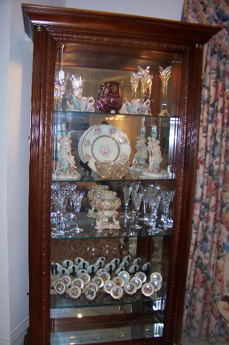 This is a wonderful mahogany curio cabinet - glass side doors - beautiful glass shelving, and lighted