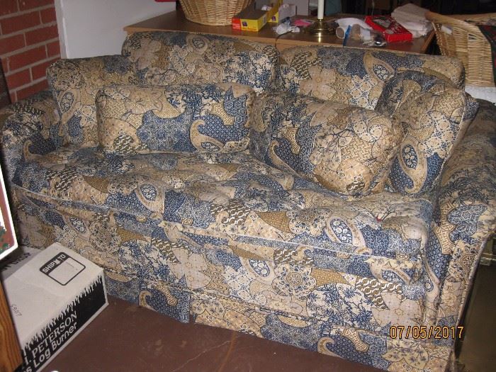 Loveseat with matching pillows and draperies.