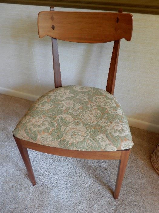 ONE OF THE FOUR WALNUT CHAIRS