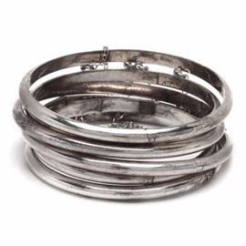 Six Hinged Sterling Silver Bangles: A group of six hinged sterling silver bangles. Each one features tab closure with safety chain, and is marked “925.” The total weight inclusive of all materials is 1.540 ozt.
