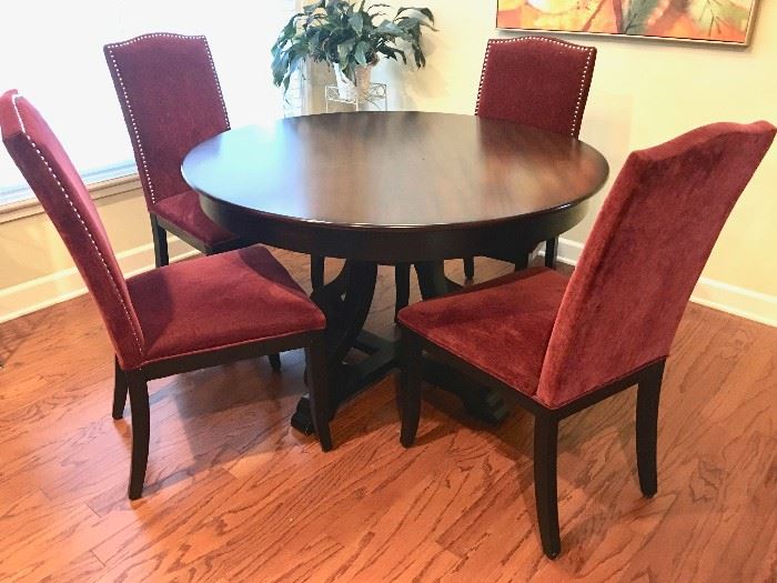 Round dining table with four velveteen arm chairs