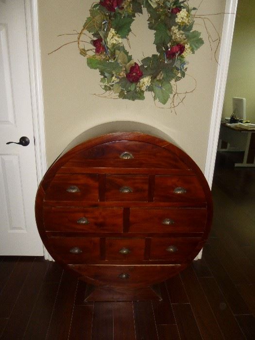 WOODEN ROUND CHEST OF DRAWERS. VERY UNIQUE AND VERSATILE PIECE OF FURNITURE FOR STORAGE AS WELL AS DISPLAY.