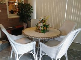 cute metal base patio table w/stone top and 4 outdoor wicker chairs