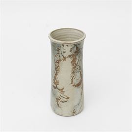 Art Pottery Vase by Banner: A signed art pottery vase. This piece features a cylindrical shape with abstract images of a nude female in earthy hues. The underside is hand signed “Banner”.